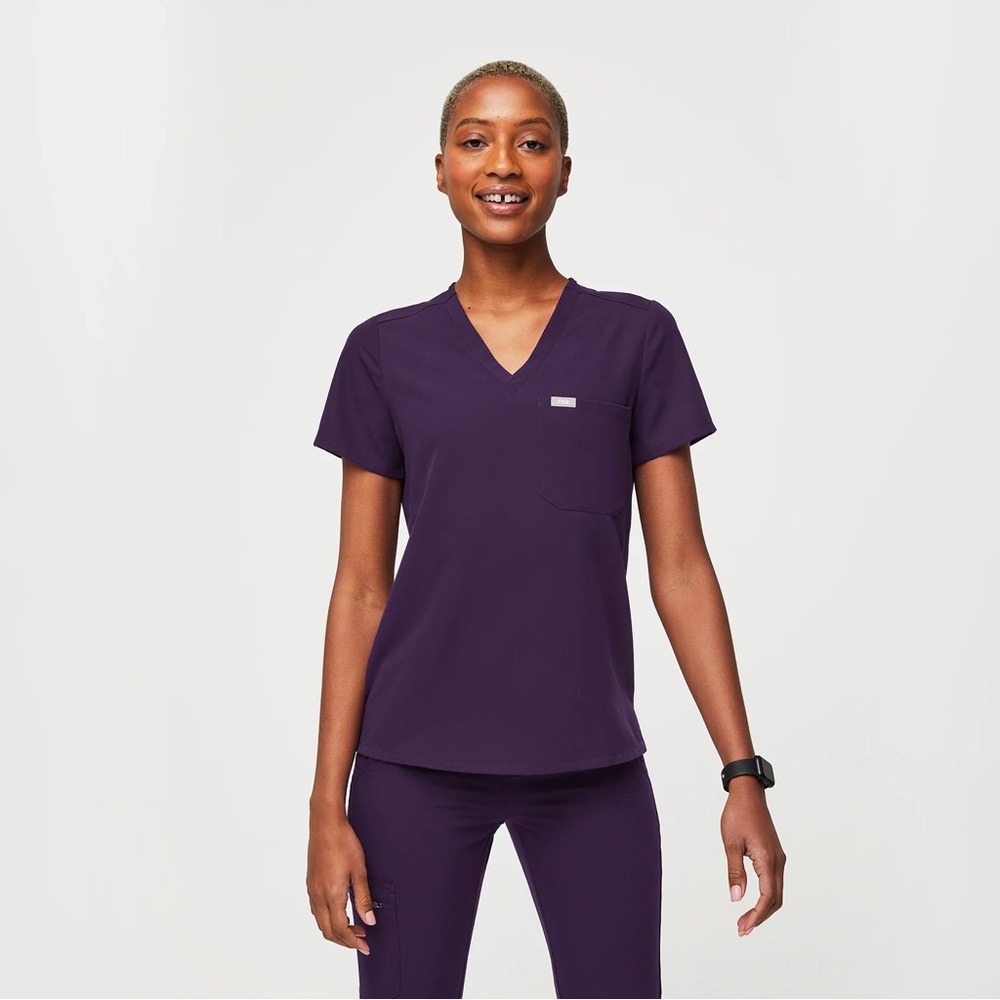 FIGS Women’s One-Pocket Scrub Top in color Purple Jam